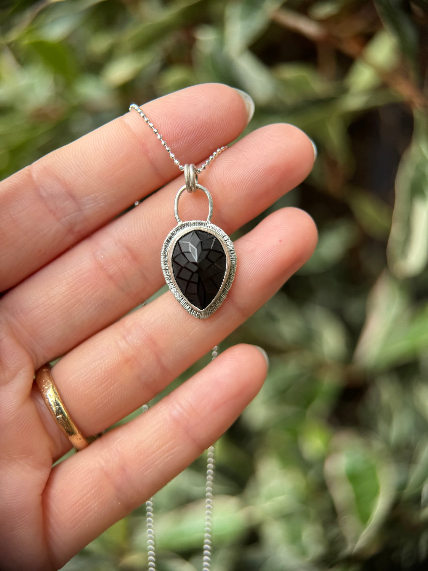 Laser carved black Spinel pendant