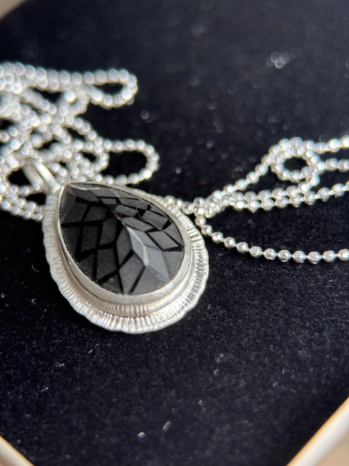 Laser carved black Spinel pendant