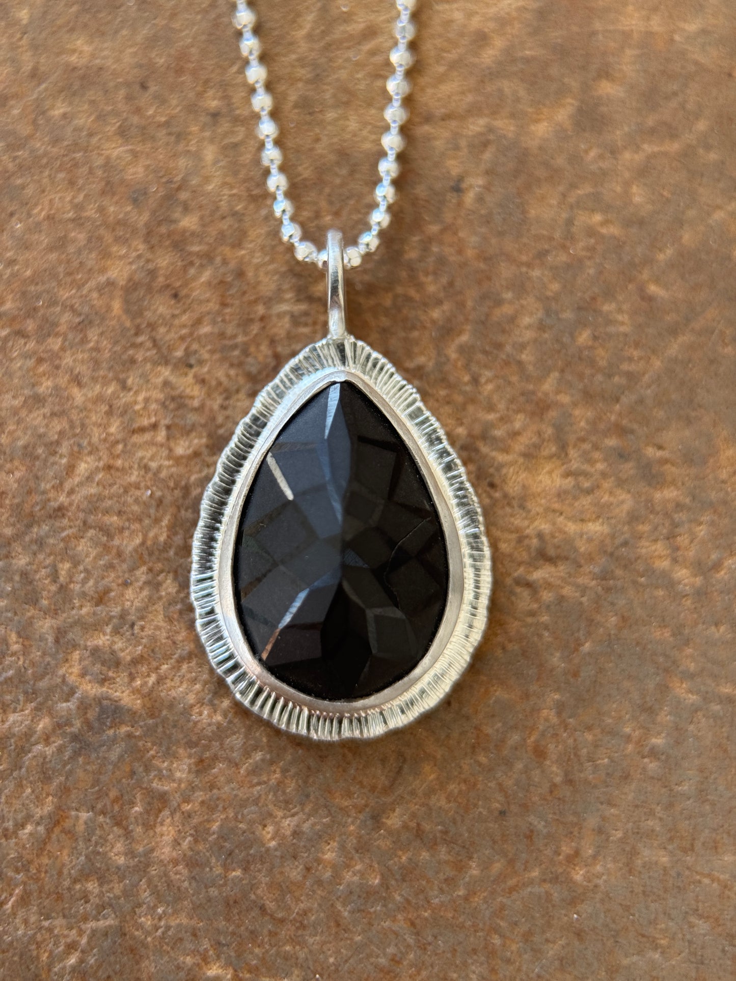 Laser carved black Spinel pendant