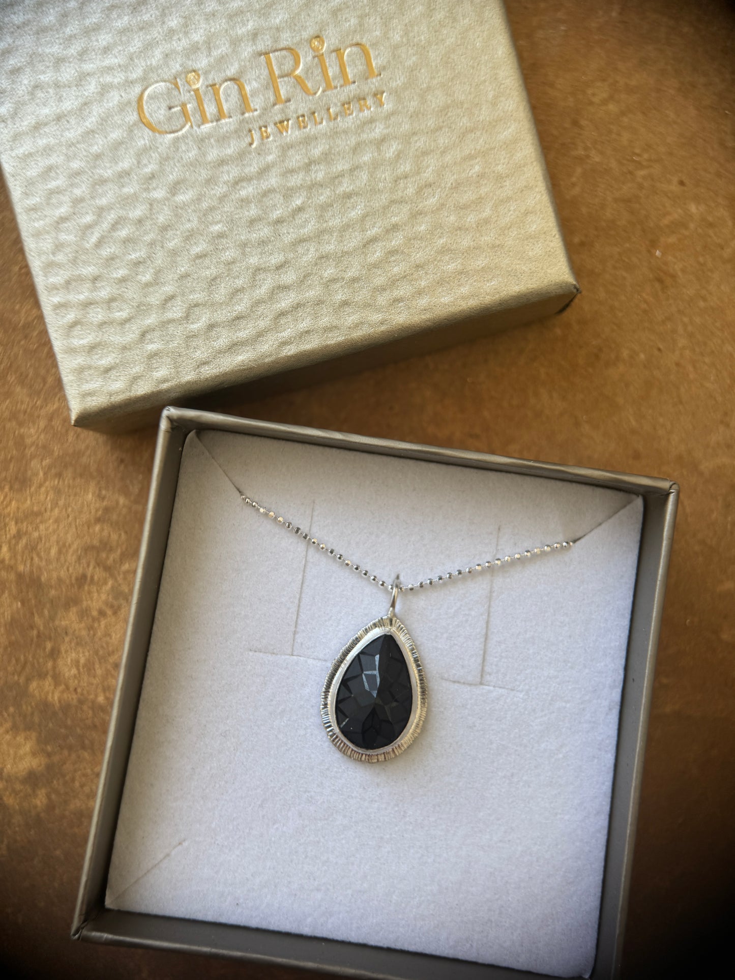 Laser carved black Spinel pendant