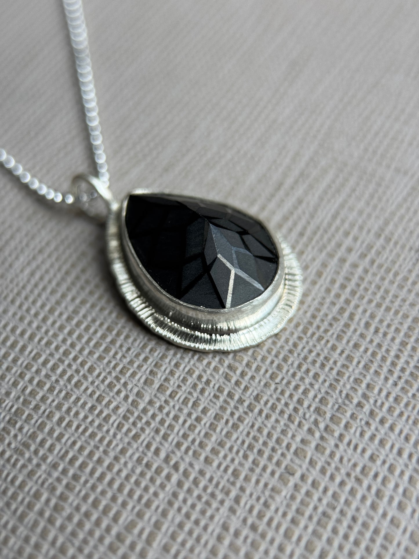 Laser carved black Spinel pendant