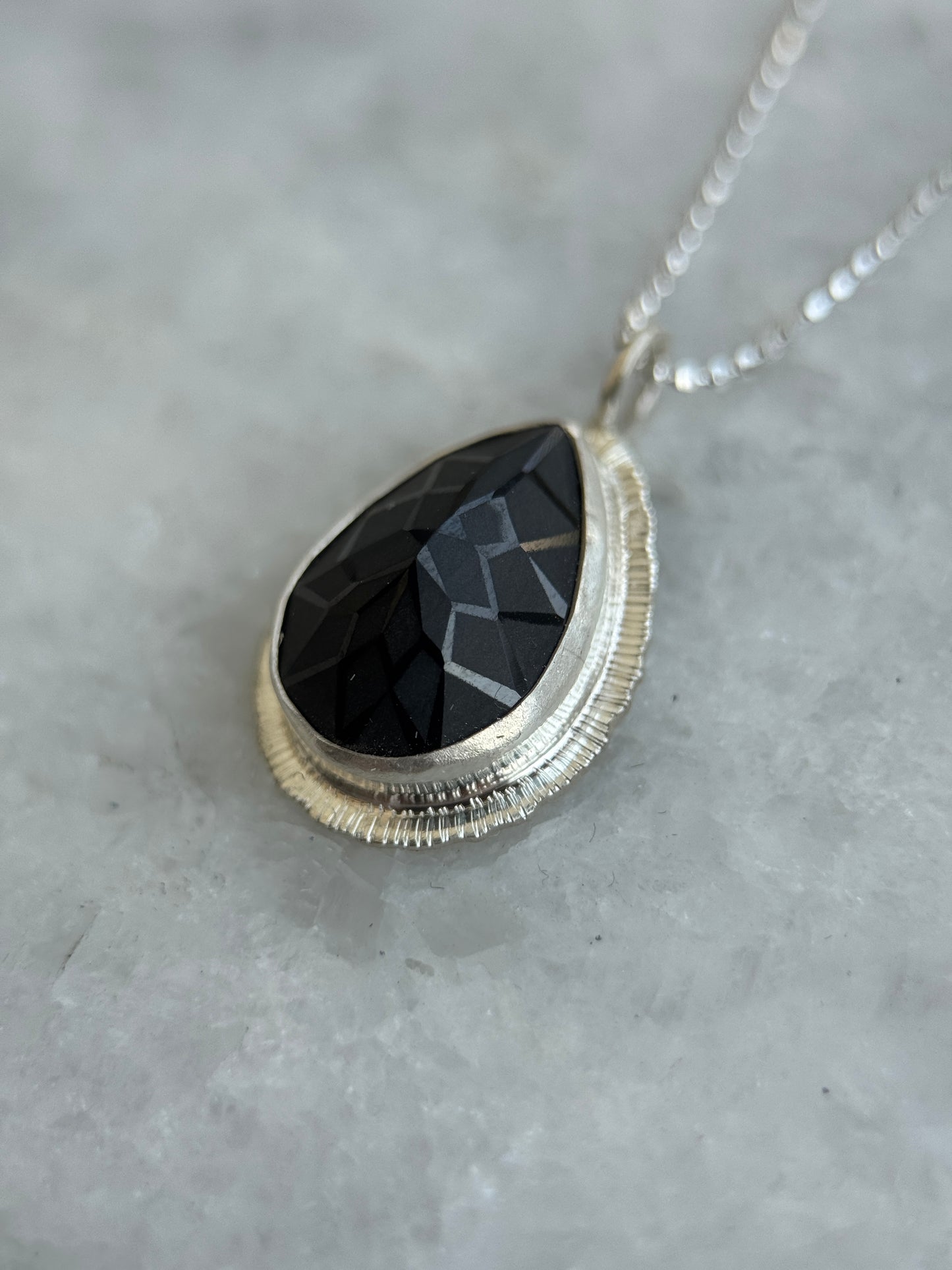 Laser carved black Spinel pendant