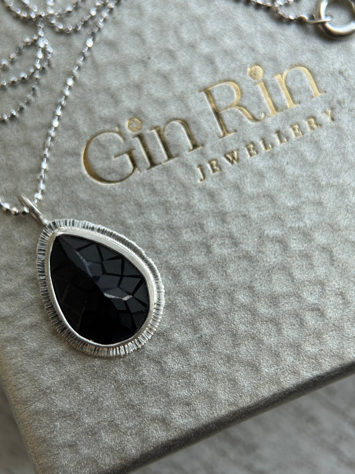 Laser carved black Spinel pendant